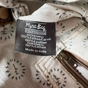 Myra Bag with Mixed Materials. Crossbody. Cow hide mixed with a floral design.